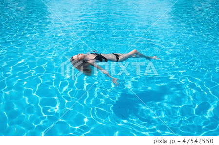 Girl relax in the pool. 47542550