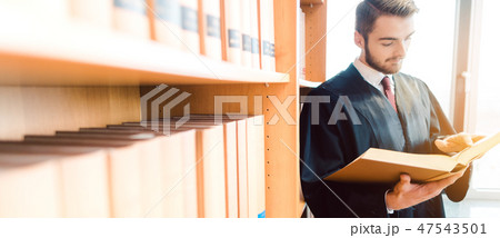 Lawyer with robe ready for court reading after the law one last time 47543501