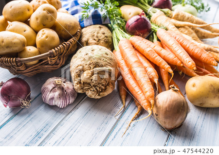 Assortment of fresh vegetables on wooden table. 47544220
