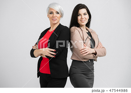 Portrait of waist-deep Two young girls standing back-to-back isolated on white background 47544986