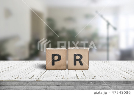 PR sign on a worn table in a bright room PR sign on a worn table in a bright room 47545086