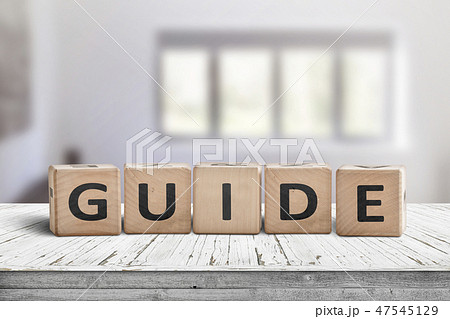 Guide sign made of wood on a desk in a bright room 47545129