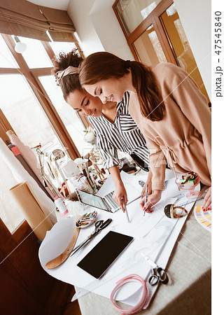 Two young attractive women talking at design studio 47545840