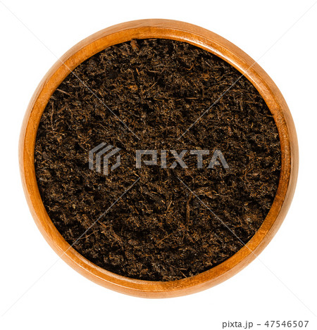 Potting soil with peat in wooden bowl over white Potting soil with peat in wooden bowl over white 47546507