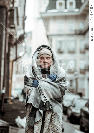 Sad serious aged woman closing her eyes Sad serious aged woman closing her eyes 47547487