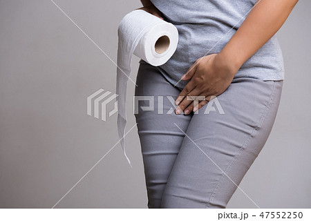 Woman hand holding her crotch lower abdomen 47552250