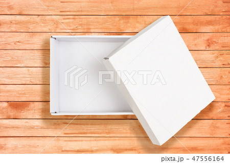 Opened white cardboard box on coral wooden background 47556164