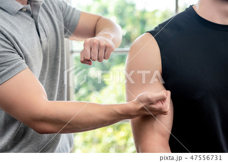 Therapist giving massage to athlete male patient  47556731