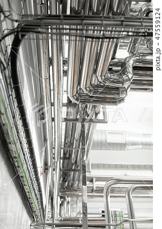 Steel pipelines and cables in factory interior as pharmaceutical industry background concept 47559124