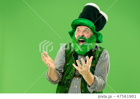 A man in a leprechaun hat at studio. He celebrates St. Patrick's Day. 47561901
