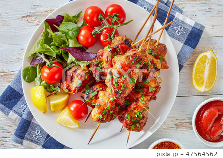chicken kebabs chargrilled on skewers, close up 47564562