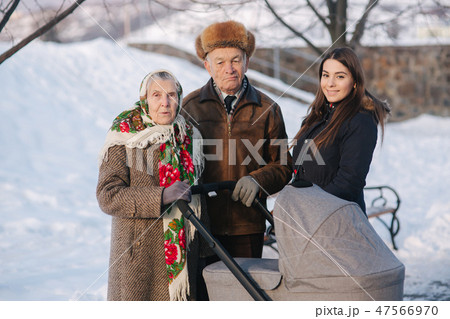 Great Grandparents walking with their granddaughter and great granddaughter 47566970