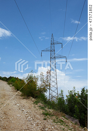 Mountain road near high voltage power line Mountain road near high voltage power line 47571802