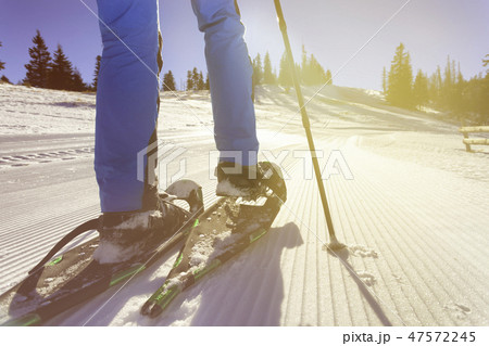 wallking in snow with snowshoe 47572245