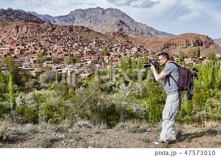 One caucasian man photographing village of Abyaneh 47573010