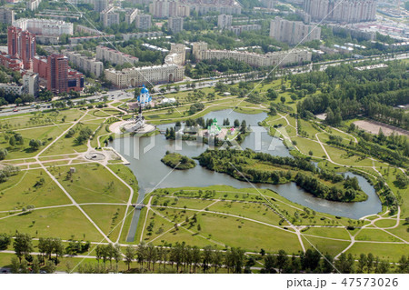 Helicopter view of city park and residential area Helicopter view of city park and residential area 47573026