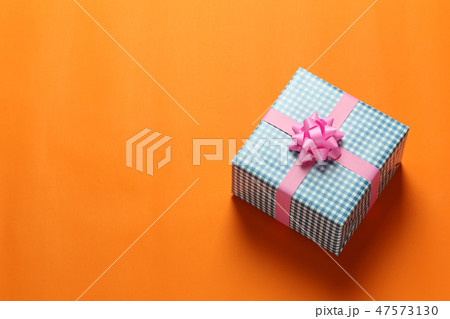 Blue Christmas gift box placed on a Orange paper. 47573130