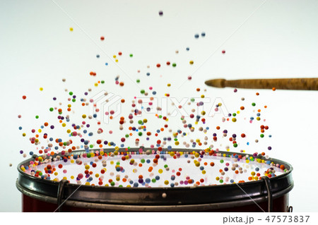 Colored balls bounces off drum in shockwave 47573837