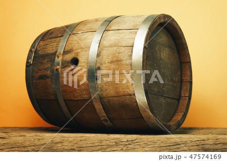 Wooden barrel and worn old table of wood. Wooden barrel and worn old table of wood. 47574169