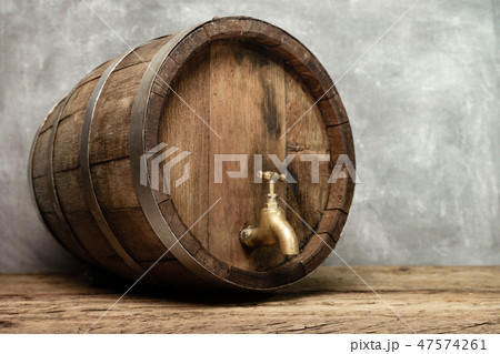 Wooden barrel with tap and worn old table of wood. Wooden barrel with tap and worn old table of wood. 47574261