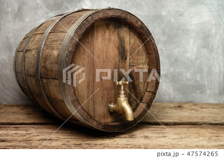 Wooden barrel with tap and worn old table of wood. 47574265