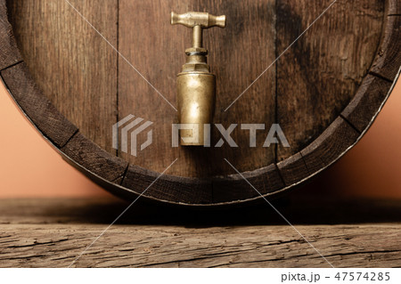 Wooden barrel with tap and worn old table of wood. Wooden barrel with tap and worn old table of wood. 47574285