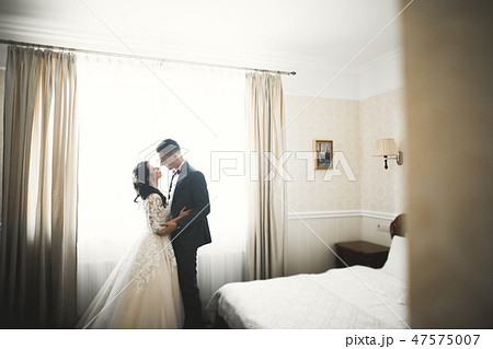 Perfect couple bride, groom posing and kissing in their wedding day 47575007