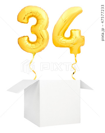 Golden number thirty four inflatable balloon with golden ribbon flying out of blank white box 47577233