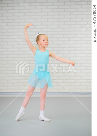 Cute little ballerina in blue dress dancing at ballet class. Cute little ballerina in blue dress dancing at ballet class. 47578054