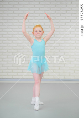 Cute little ballerina in blue dress dancing at ballet class. 47578055