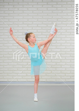 Cute little ballerina in blue dress dancing at ballet class. Cute little ballerina in blue dress dancing at ballet class. 47578056