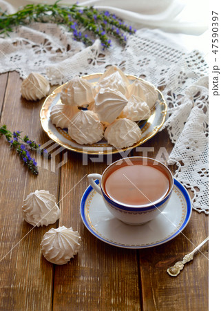 A bowl of home-made meringues with tea. 47590397