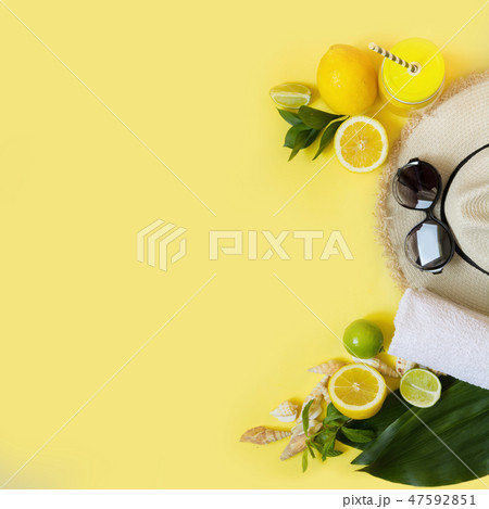 Beach accessory with citrics water on yellow. Beach accessory with citrics water on yellow. 47592851