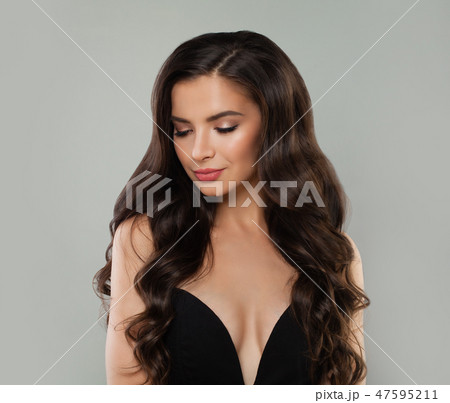Brunette beauty. Nice woman with long wavy hair Brunette beauty. Nice woman with long wavy hair 47595211