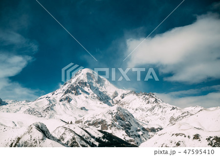 Georgia. Peak Of Mount Kazbek Covered With Snow. Kazbek Is A Stratovolcano And One Of Major Georgia. Peak Of Mount Kazbek Covered With Snow. Kazbek Is A Stratovolcano And One Of Major 47595410
