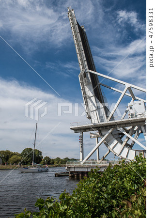 Boat passing under Pegasus Bridge in Normandy Boat passing under Pegasus Bridge in Normandy 47598331