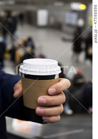 man having a takeout cup of coffee man having a takeout cup of coffee 47598898