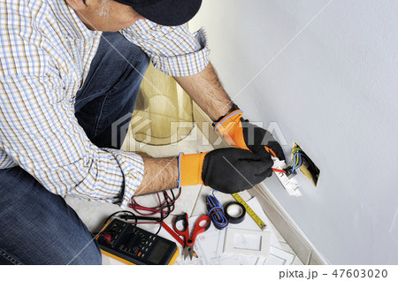 Electrician working in a residential electrical system Electrician working in a residential electrical system 47603020