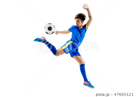 Young boy with soccer ball doing flying kick Young boy with soccer ball doing flying kick 47603121