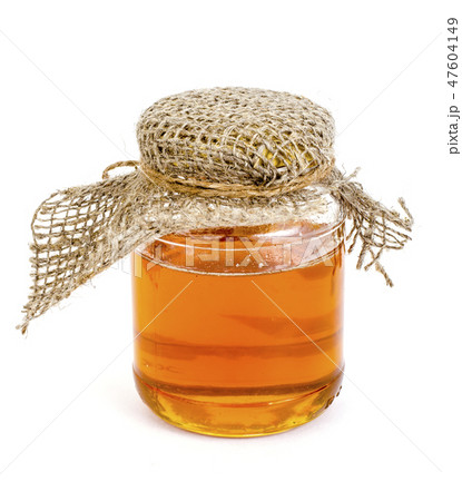 Glass jar with delicious fresh honey isolated Glass jar with delicious fresh honey isolated 47604149