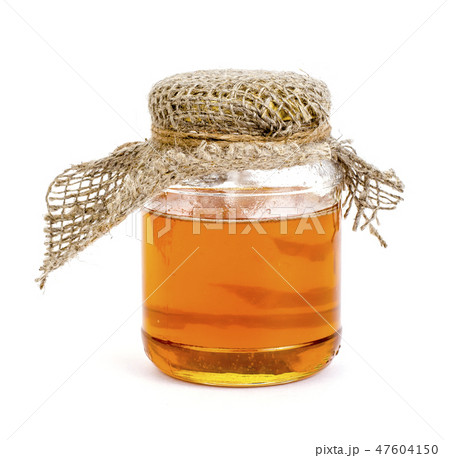Glass jar with delicious fresh honey isolated Glass jar with delicious fresh honey isolated 47604150