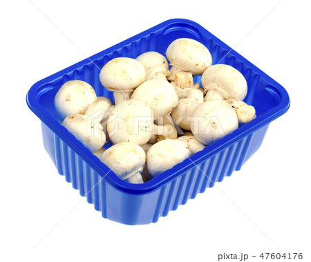 Fresh white champignons in blue plastic packaging Fresh white champignons in blue plastic packaging 47604176