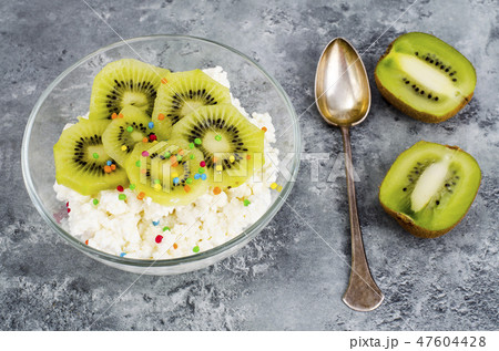 Cottage cheese with kiwi in glass bowl isolated Cottage cheese with kiwi in glass bowl isolated 47604428