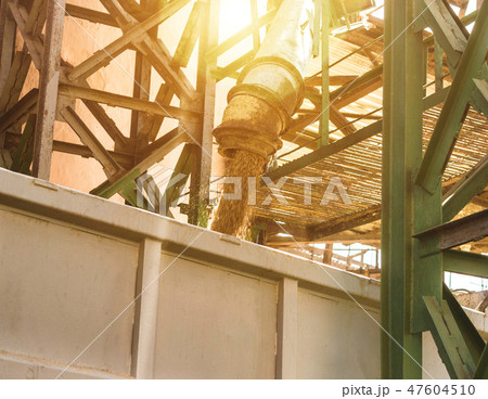 Plant for processing and storing grain, a truck is loaded with grain, close up, loaded corn 47604510