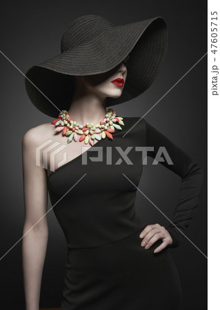 portrait of young lady with black hat and evening dress 47605715