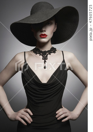 portrait of young lady with black hat and evening dress portrait of young lady with black hat and evening dress 47605725