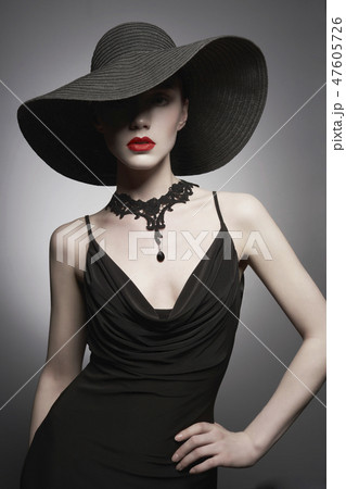 portrait of young lady with black hat and evening dress 47605726