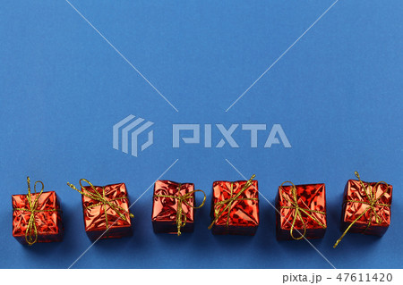 Red Gift Box of Christmas decorations on blue background and have copy space. Red Gift Box of Christmas decorations on blue background and have copy space. 47611420