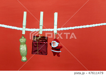 Santa doll hang on the clothesline and have copy space with red background. Santa doll hang on the clothesline and have copy space with red background. 47611479