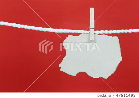 Empty old note paper hang on the clothesline and have copy space with red background. 47611495